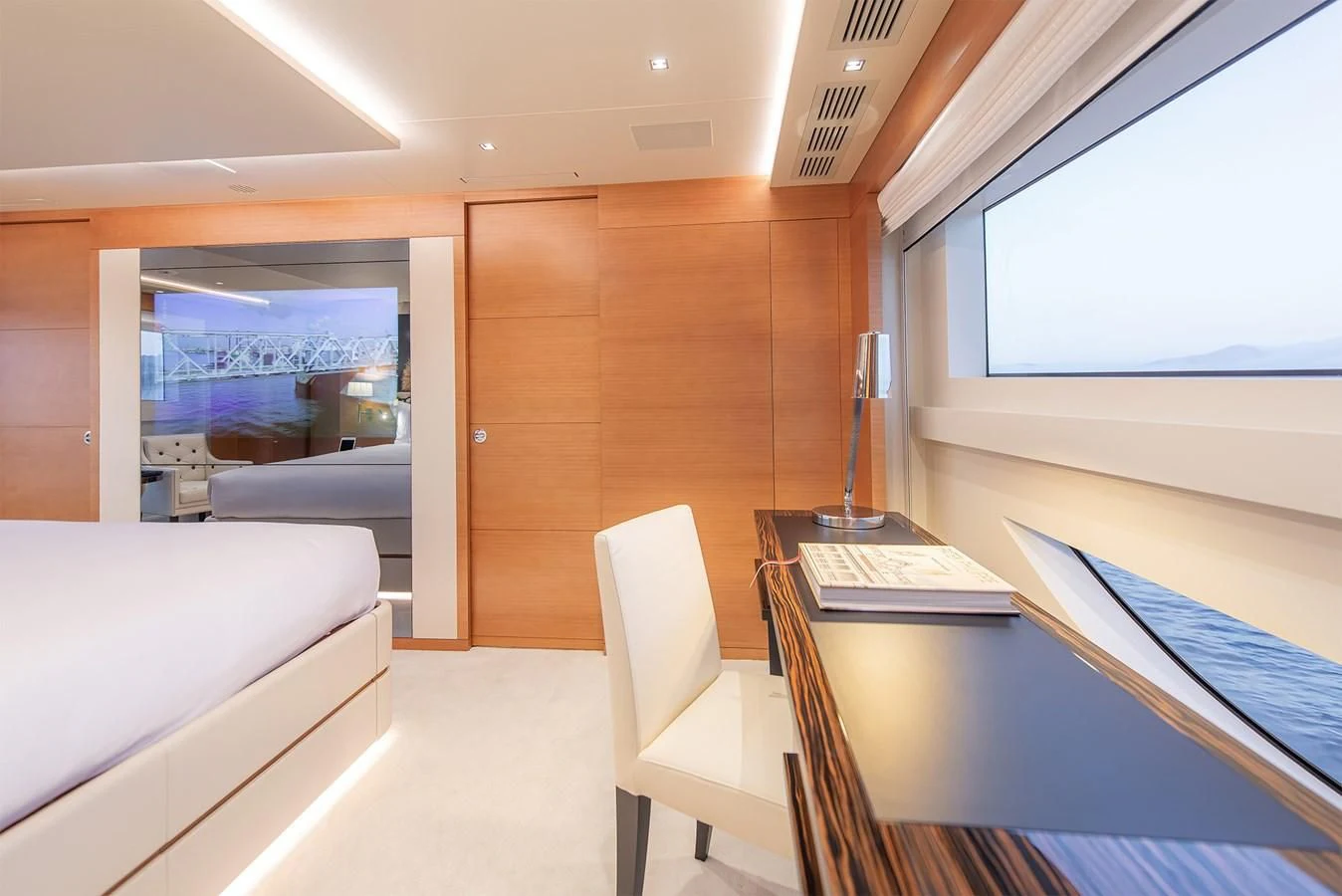 a room with a desk and a bed aboard TONIC BLUE Yacht for Sale