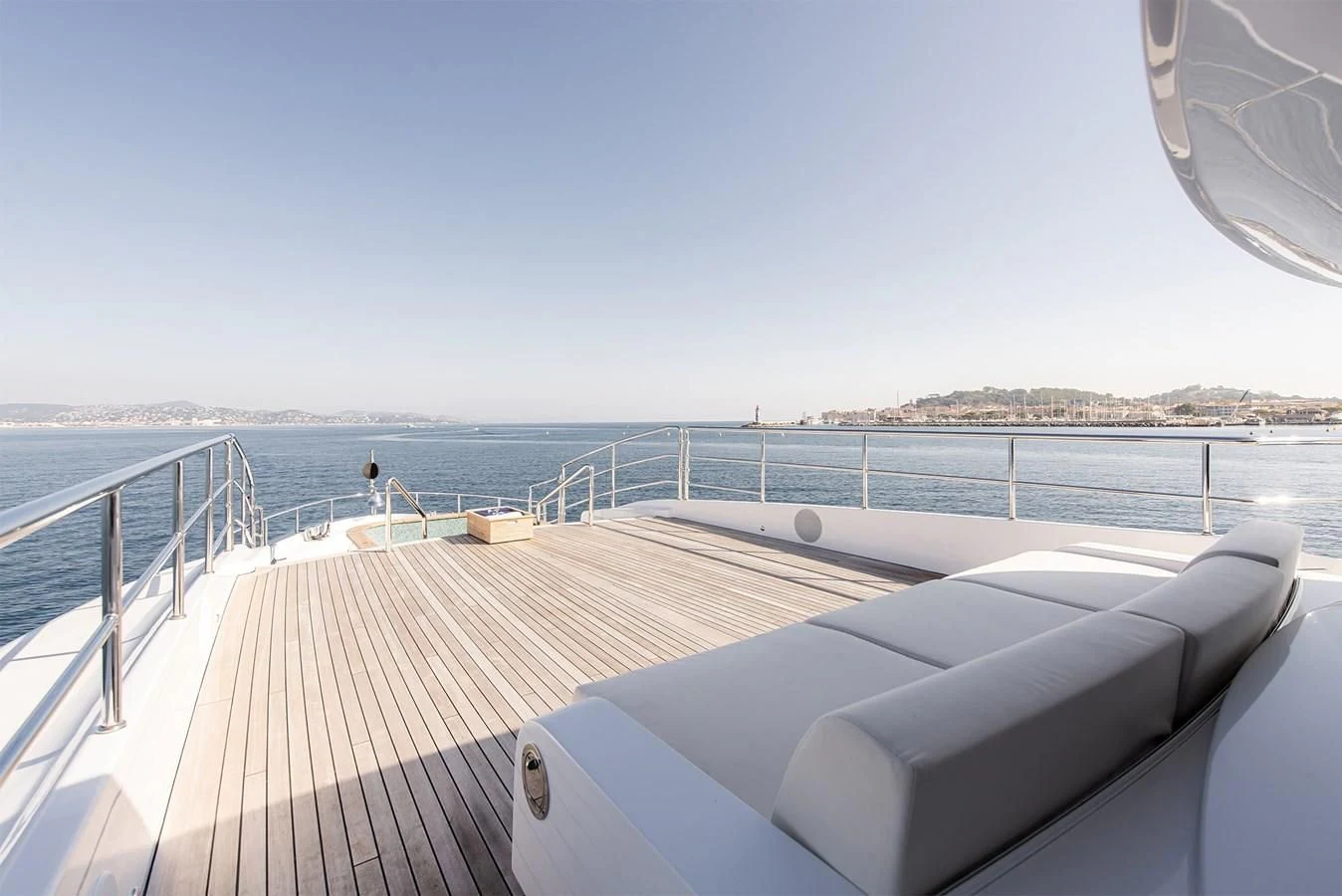 a deck with a railing and water aboard TONIC BLUE Yacht for Sale