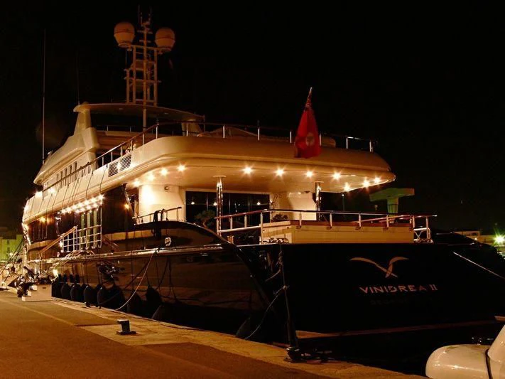 a large cruise ship docked at night aboard SEA D Yacht for Sale