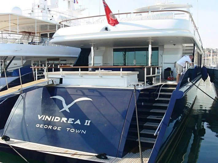 a boat with a flag on the deck aboard SEA D Yacht for Sale