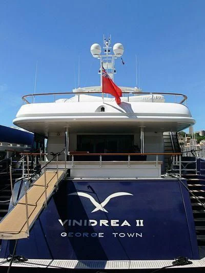 a large boat with a flag on it aboard SEA D Yacht for Sale