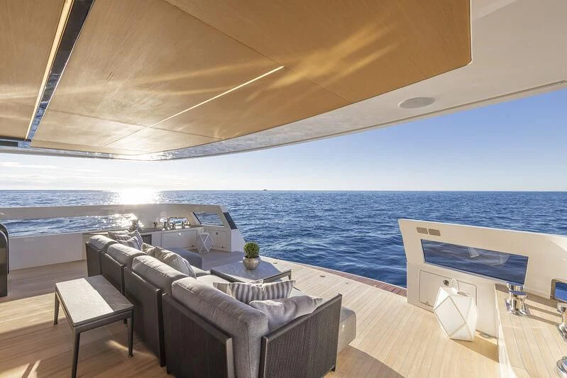 a room with a couch and a table and a large body of water aboard SOLEIL Yacht for Sale