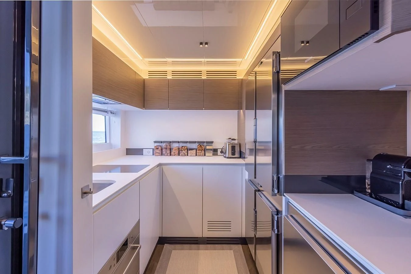 a kitchen with white cabinets aboard SOLEIL Yacht for Sale
