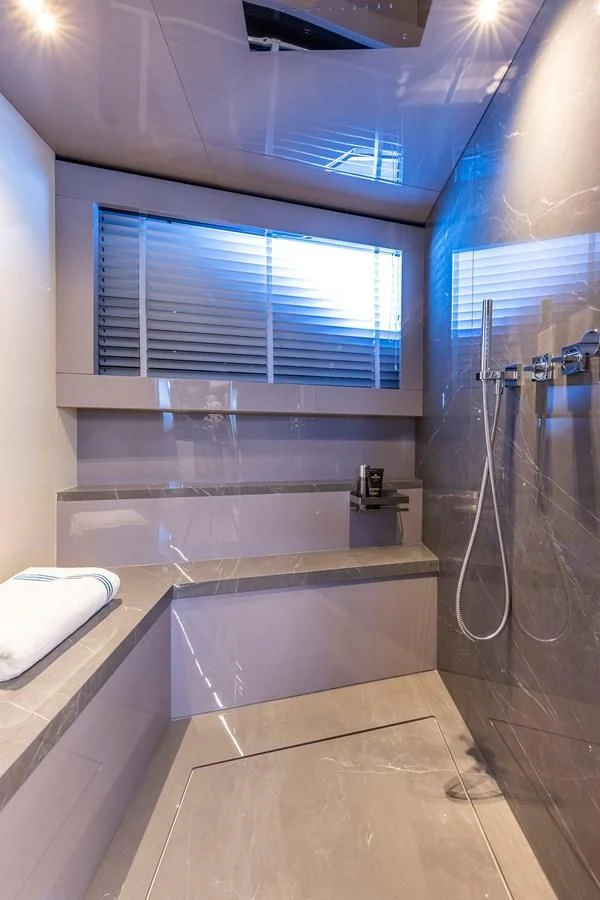 a bathroom with a shower and tub aboard SOLEIL Yacht for Sale
