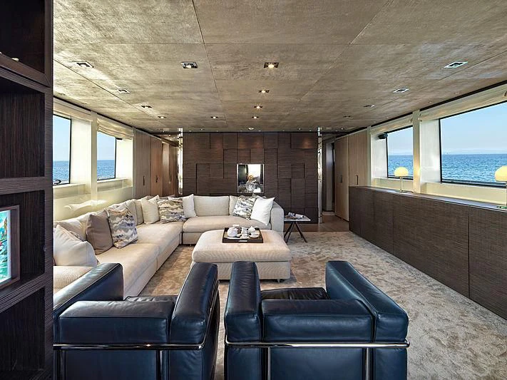 a living room with a couch and a table aboard CASA Yacht for Sale