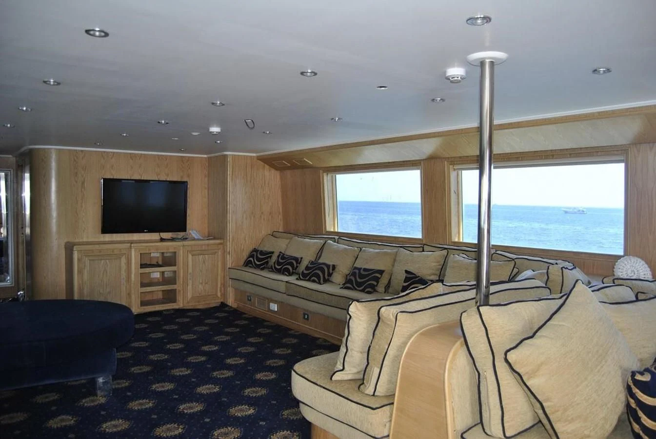 a living room with a couch and a tv aboard SCUBA SCENE Yacht for Sale