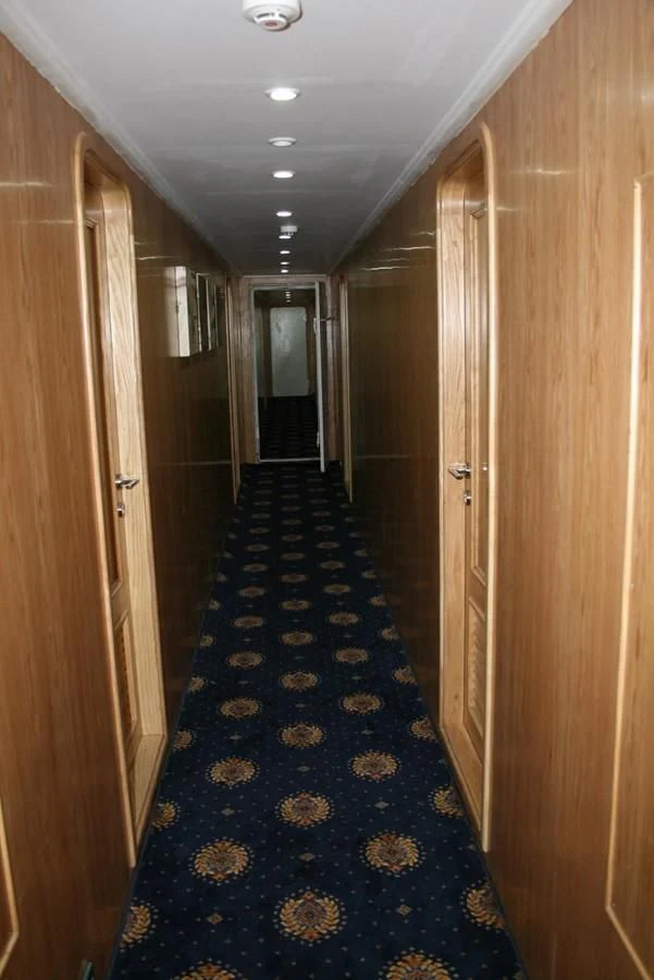 a hallway with doors aboard SCUBA SCENE Yacht for Sale