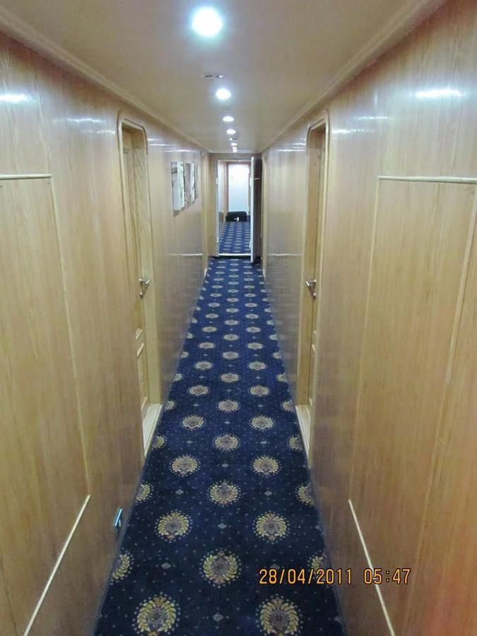 a hallway with a blue carpet aboard SCUBA SCENE Yacht for Sale
