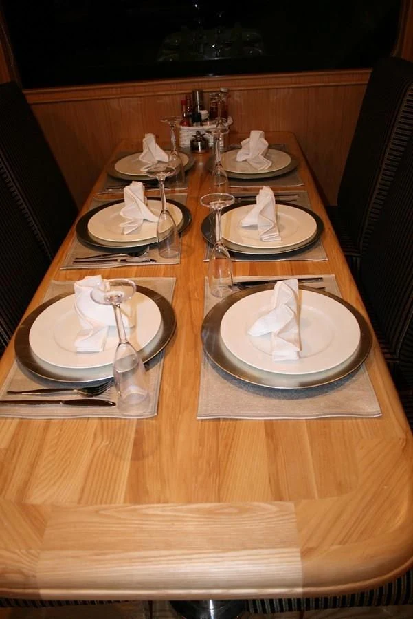 a table with plates and glasses aboard SCUBA SCENE Yacht for Sale