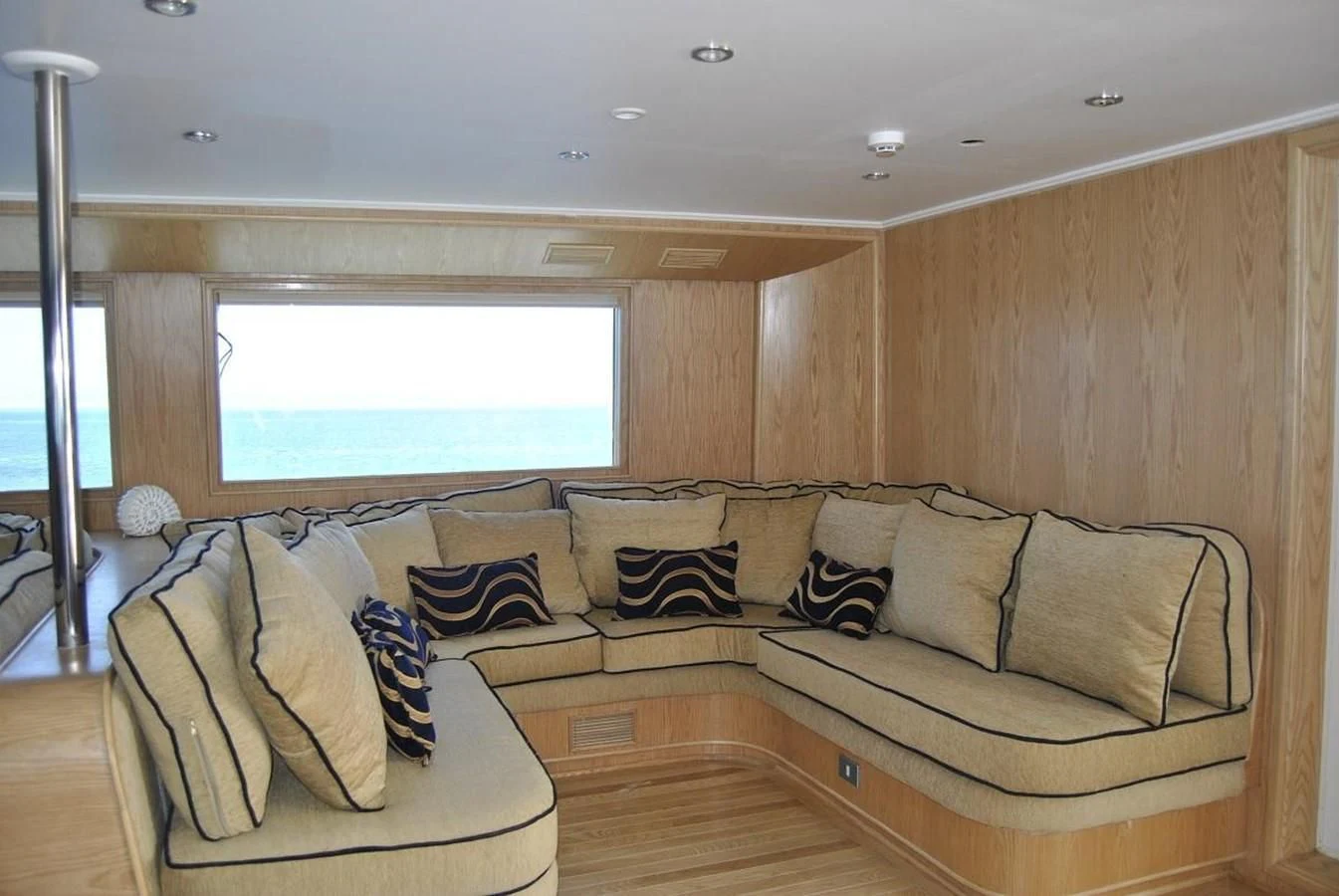 a living room with a couch and a window aboard SCUBA SCENE Yacht for Sale