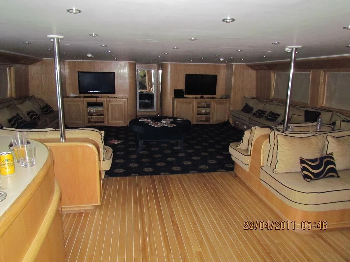 a living room with a couch and a tv aboard SCUBA SCENE Yacht for Sale