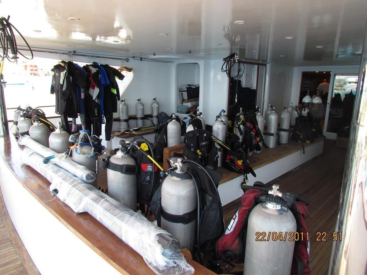 a room with many bottles and other objects on shelves aboard SCUBA SCENE Yacht for Sale