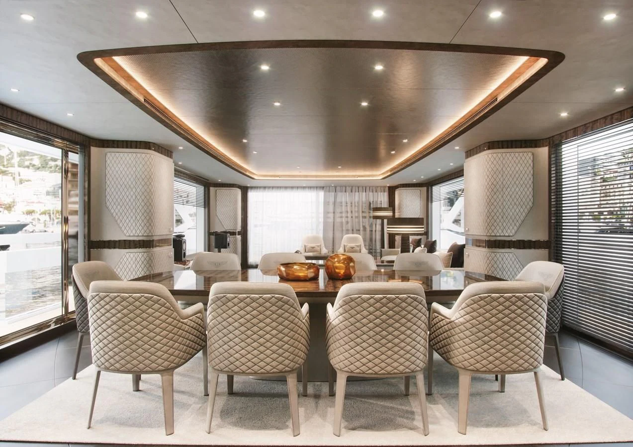 a large dining room with a table and chairs aboard DYNAMIQ GLOBAL 350 Yacht for Sale