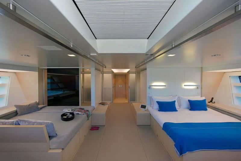 a room with a bed and a desk aboard BETTER PLACE Yacht for Sale
