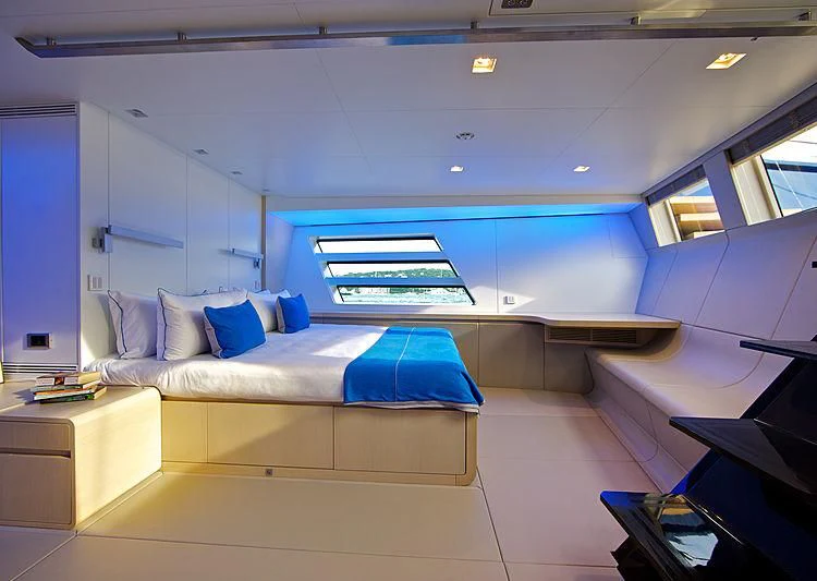 a room with a bed and a desk aboard BETTER PLACE Yacht for Sale