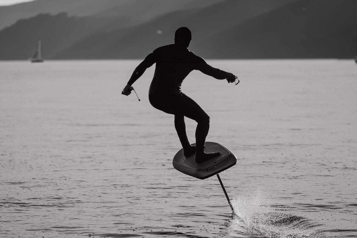 a man is water skiing aboard SERENISSIMA III Yacht for Charter