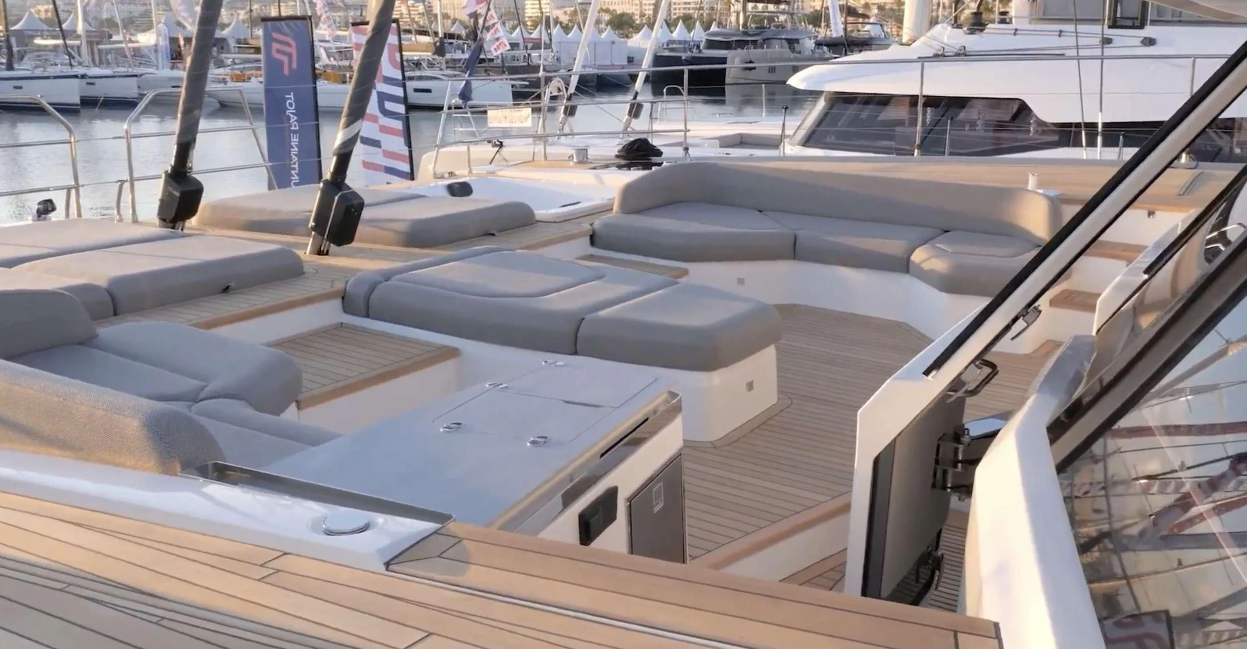 a room with a row of seats and a table with chairs aboard SERENISSIMA III Yacht for Charter