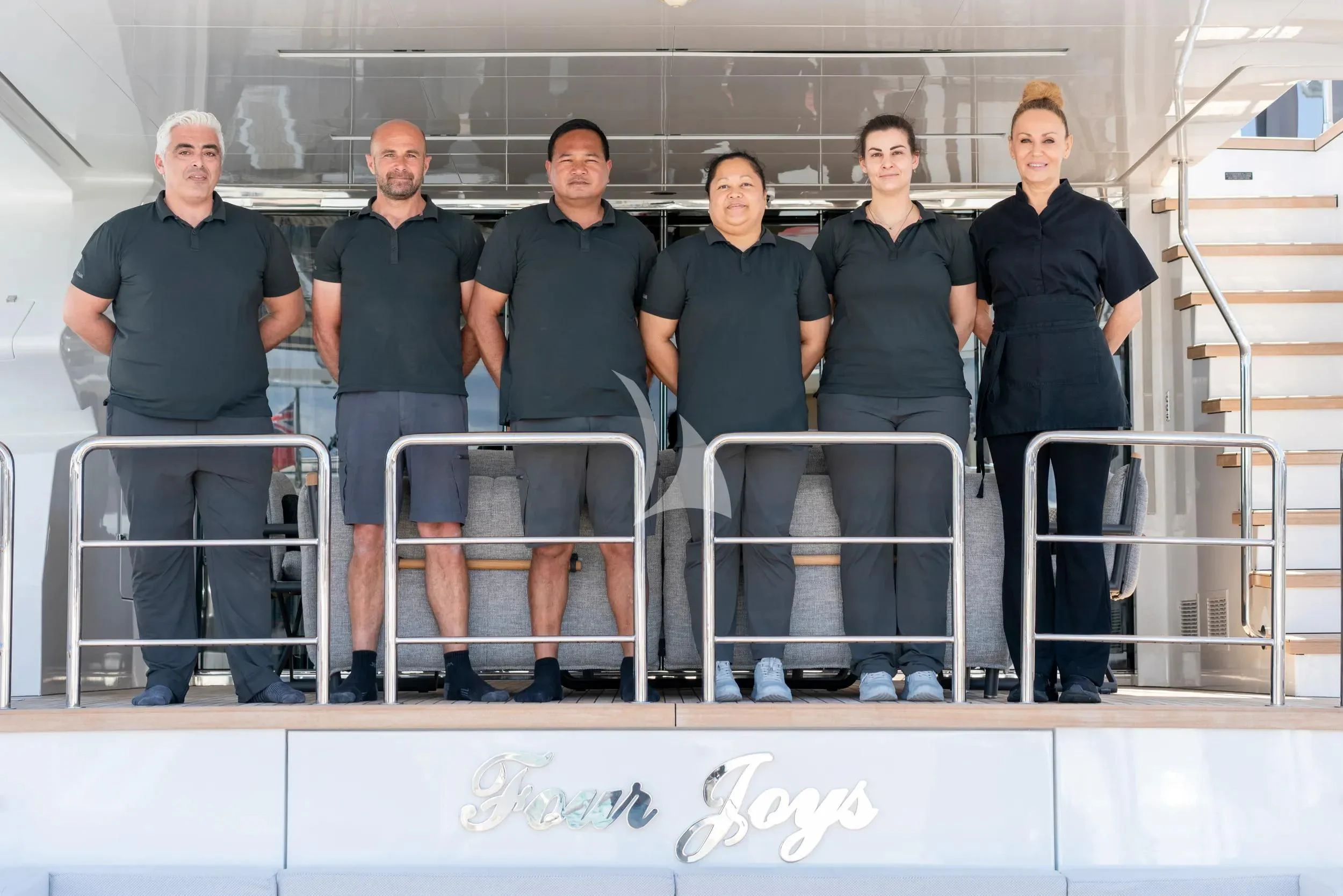 a group of people posing for a photo aboard FOUR JOYS Yacht for Sale