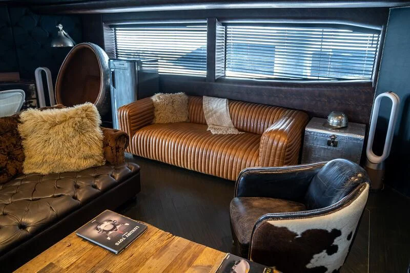 a living room with couches and chairs aboard BABYLON Yacht for Sale