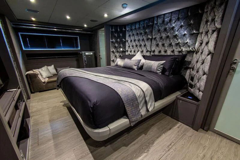 a bedroom with a large bed aboard BABYLON Yacht for Sale