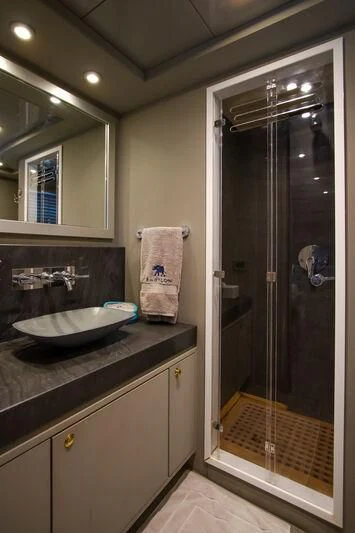 a bathroom with a glass shower door aboard BABYLON Yacht for Sale