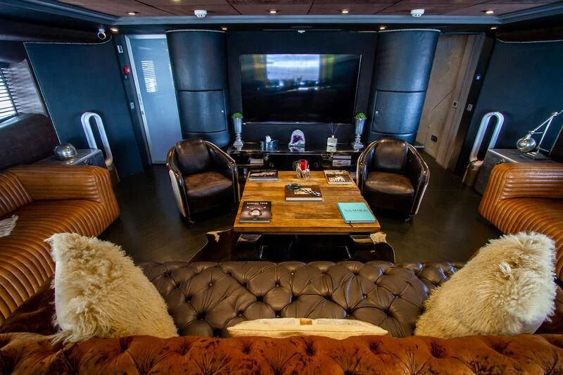 a living room with a couch and a tv aboard BABYLON Yacht for Sale