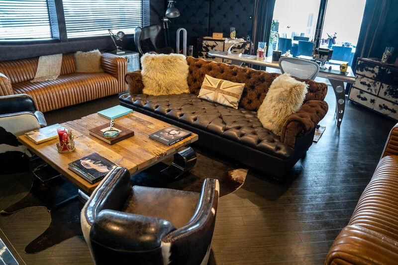 a living room with a leather couch aboard BABYLON Yacht for Sale