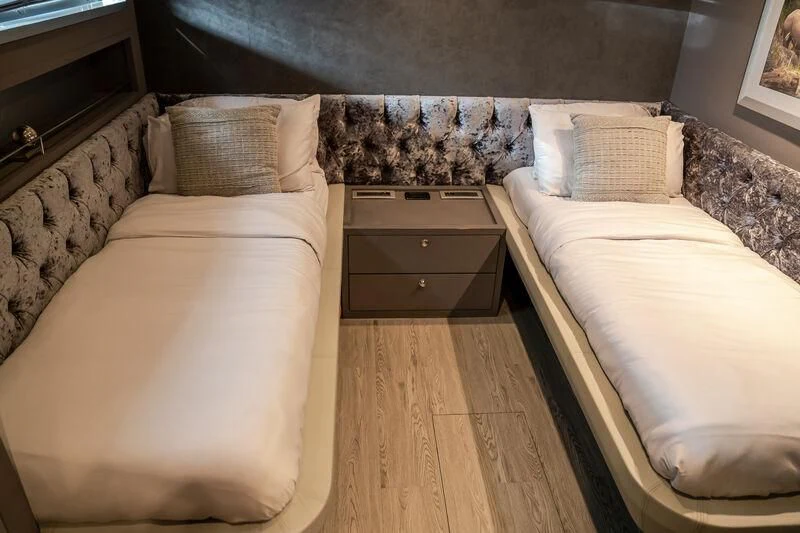 a room with a bed and a dresser aboard BABYLON Yacht for Sale