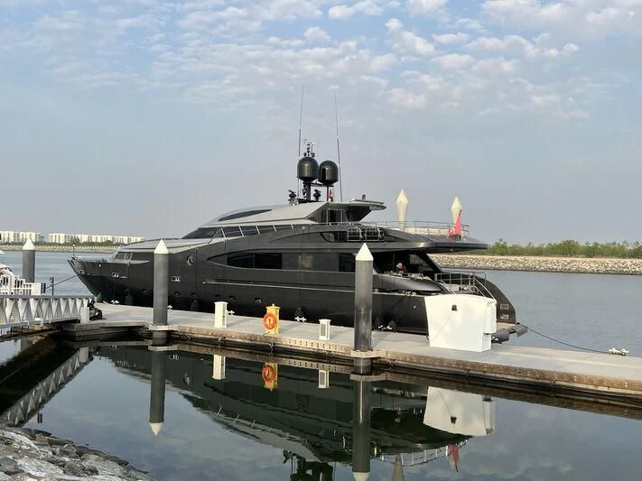 a large boat docked at a pier aboard BABYLON Yacht for Sale