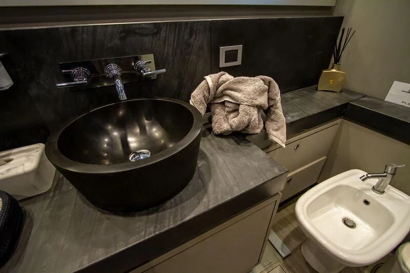 a bathroom with a sink and a large mirror aboard BABYLON Yacht for Sale