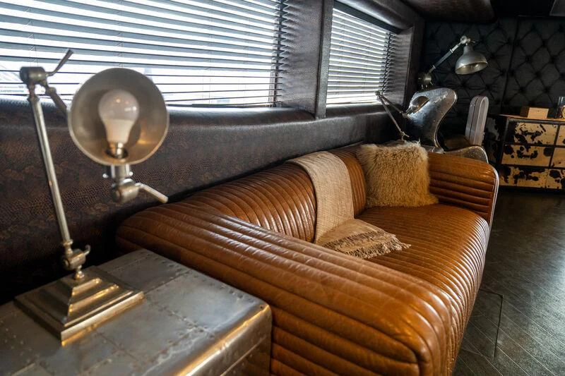a couch with a lamp on top aboard BABYLON Yacht for Sale
