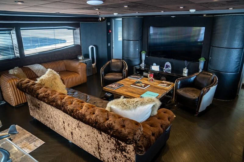 a living room with leather furniture aboard BABYLON Yacht for Sale