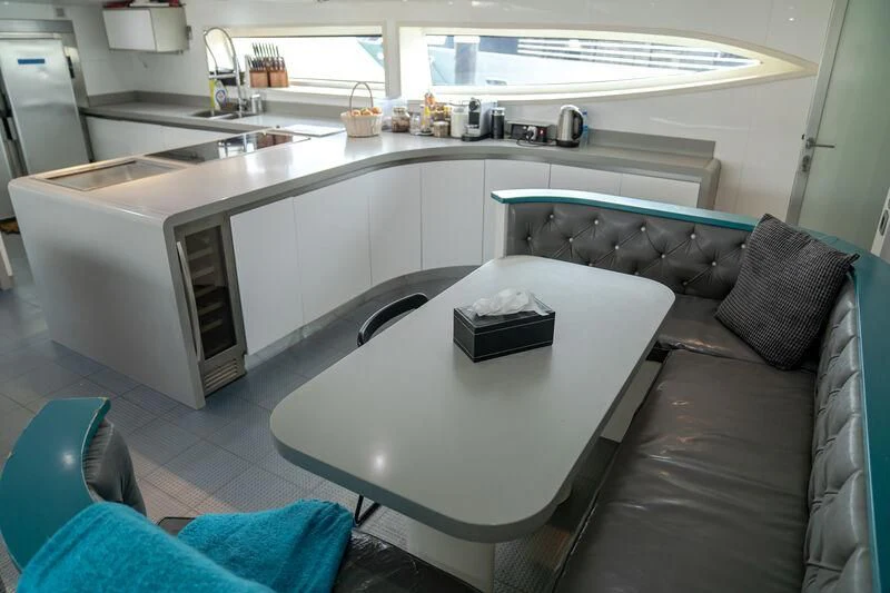 a kitchen with a couch and a table aboard BABYLON Yacht for Sale