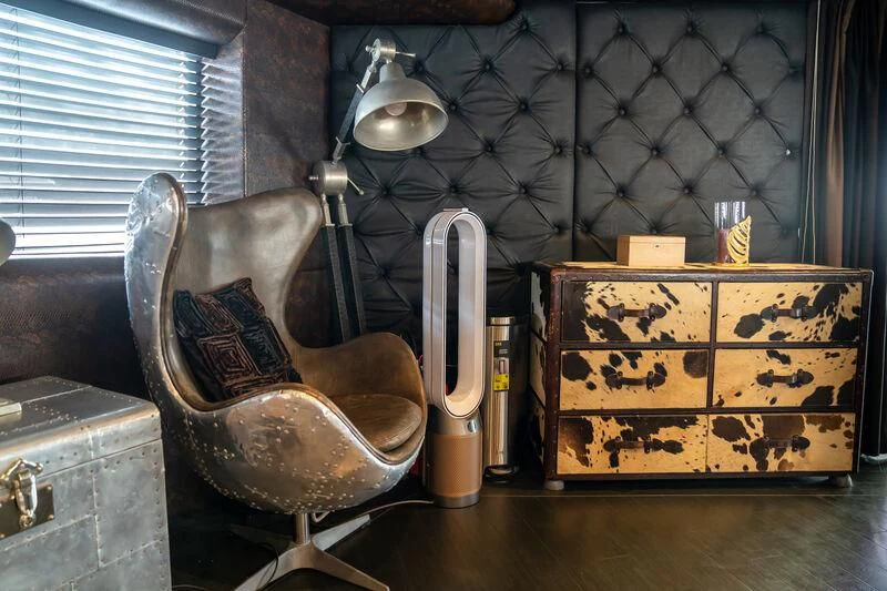 a room with a chair and a couch aboard BABYLON Yacht for Sale