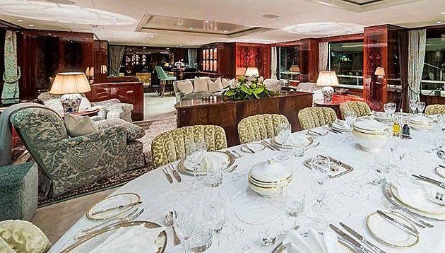 a large room with a table and chairs aboard LA FAMILIA Yacht for Sale