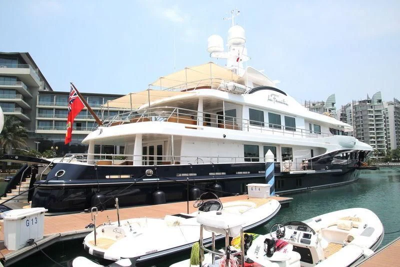 a large boat docked at a pier aboard LA FAMILIA Yacht for Sale