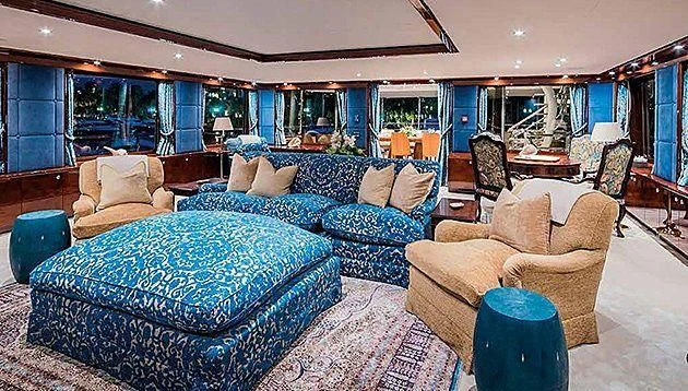 a living room with a blue couch aboard LA FAMILIA Yacht for Sale