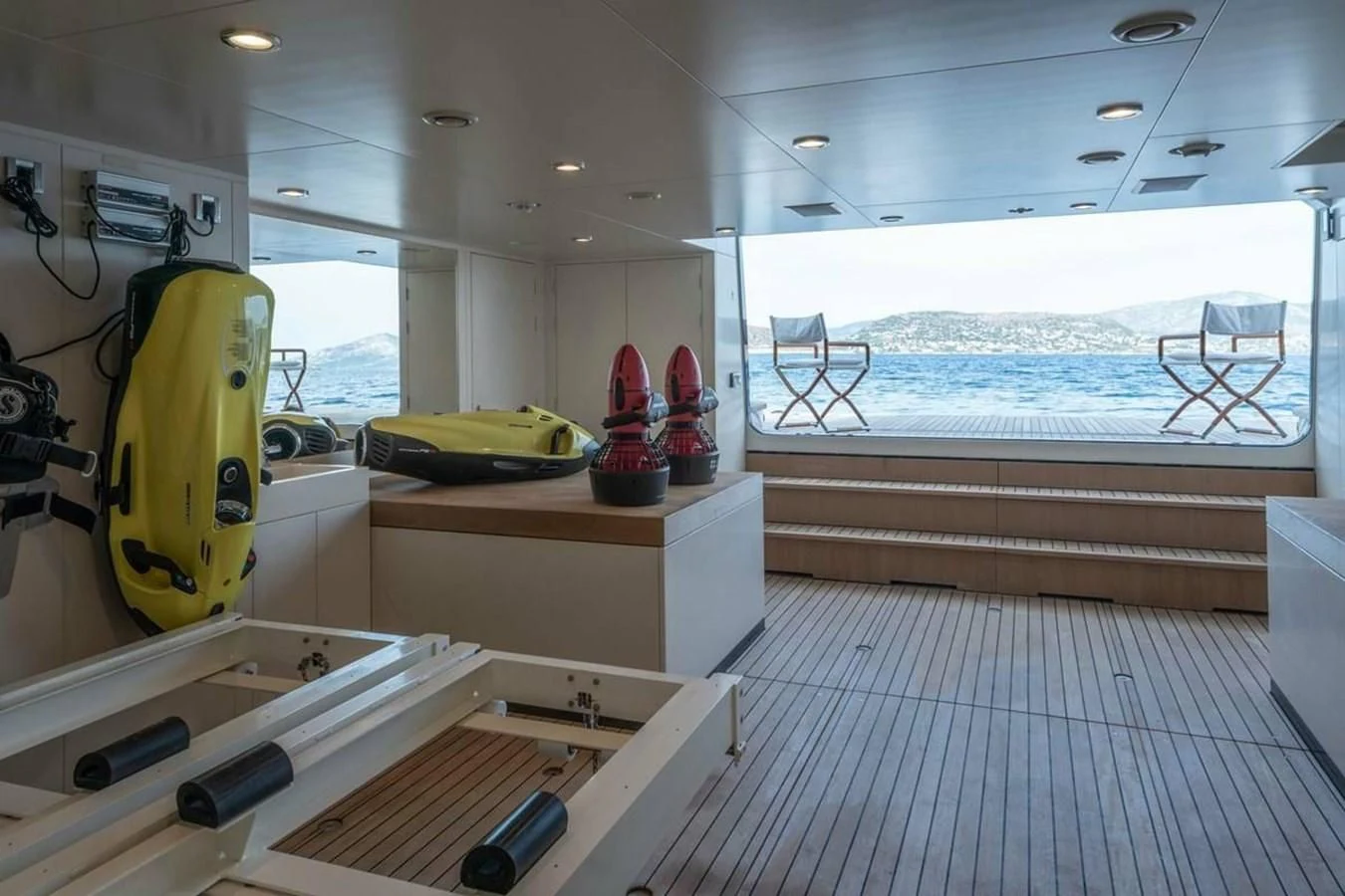 a room with a deck and a pool aboard LA FAMILIA Yacht for Sale