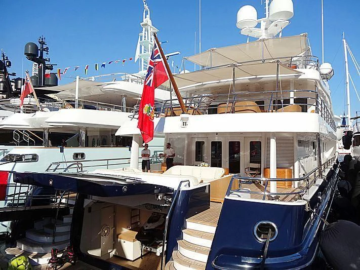 a boat with a flag on the front aboard LA FAMILIA Yacht for Sale