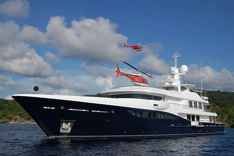 a boat with a helicopter flying over it aboard LA FAMILIA Yacht for Sale