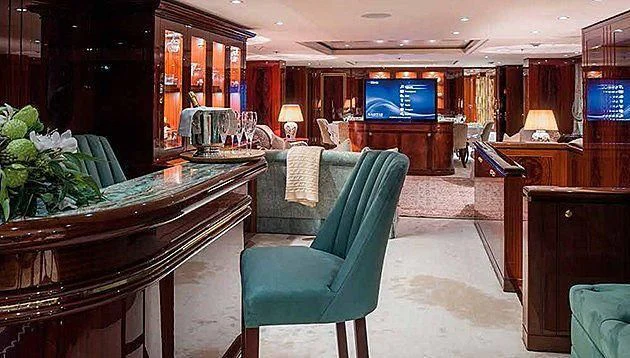 a room with a table and chairs aboard LA FAMILIA Yacht for Sale