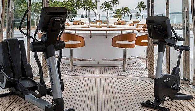 a set of black and white tripods on a wooden deck aboard LA FAMILIA Yacht for Sale
