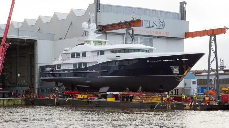 a large boat docked at a pier aboard LA FAMILIA Yacht for Sale