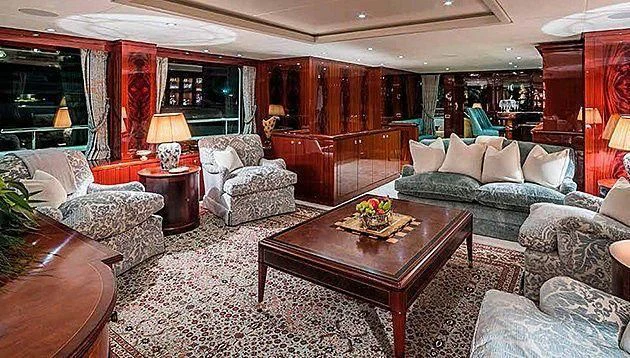 a living room with a couch and a coffee table aboard LA FAMILIA Yacht for Sale