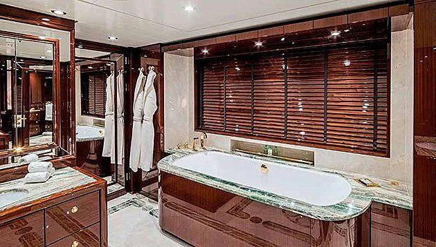 a bathroom with a tub and a sink aboard LA FAMILIA Yacht for Sale