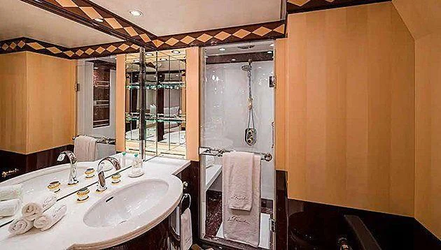 a bathroom with a sink and a mirror aboard LA FAMILIA Yacht for Sale