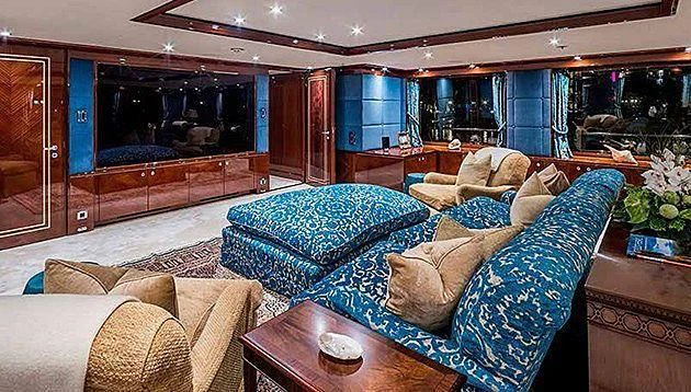 a living room with a couch and a fireplace aboard LA FAMILIA Yacht for Sale