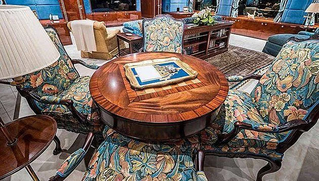 a living room with a table and chairs aboard LA FAMILIA Yacht for Sale