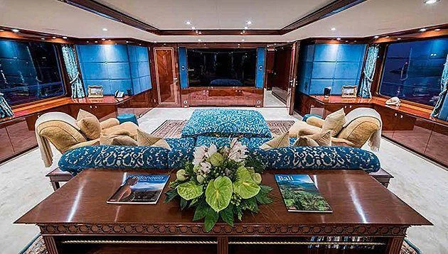 a living room with a large sofa aboard LA FAMILIA Yacht for Sale