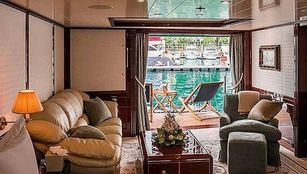 a living room with a view of the water and the city aboard LA FAMILIA Yacht for Sale